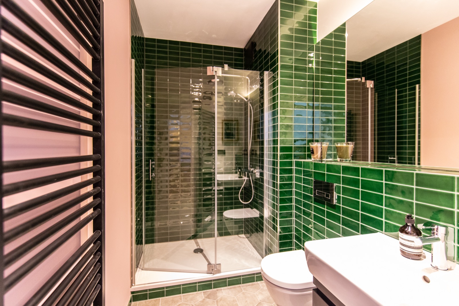 Bathroom with green tiles and a walk-in shower