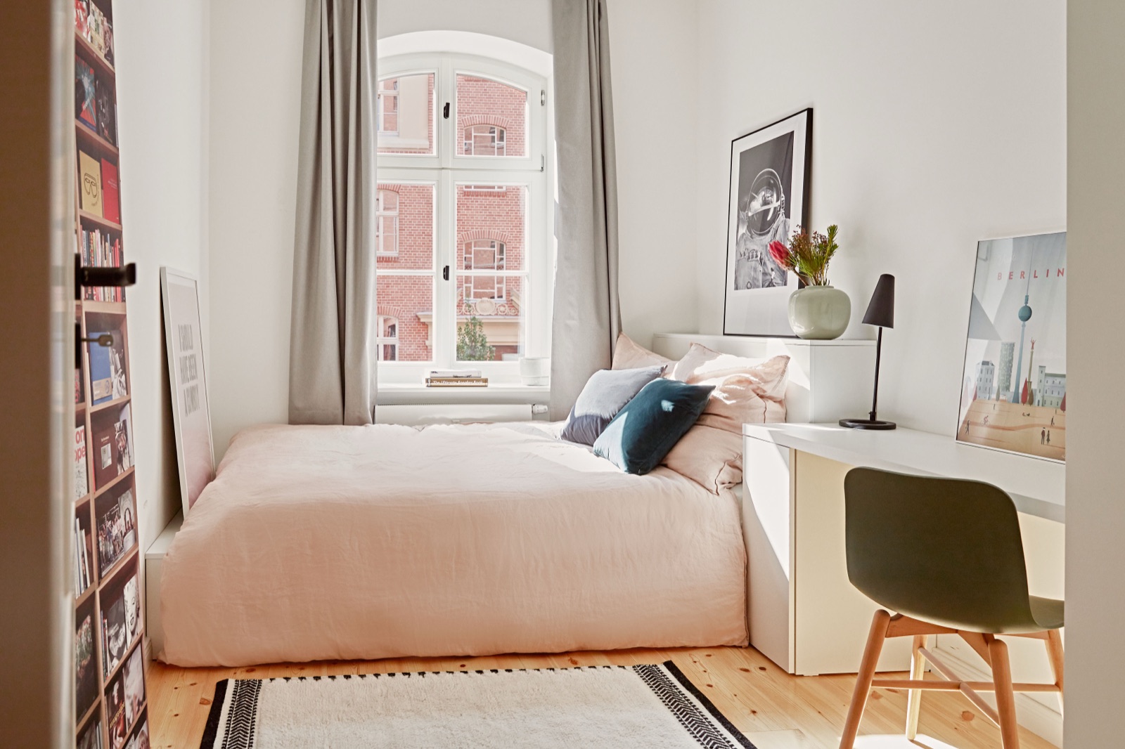 Bedroom with soft daylight and a view over the courtyard